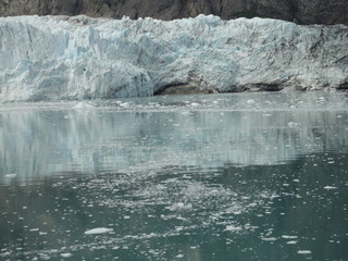 Fototapeta na wymiar Glacier in the midst of gray mountains with little vegetation in Alaska