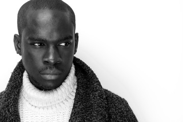 black and white portrait of handsome young black man against isolated white background
