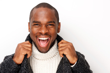 happy african american man laughing against white background with coat