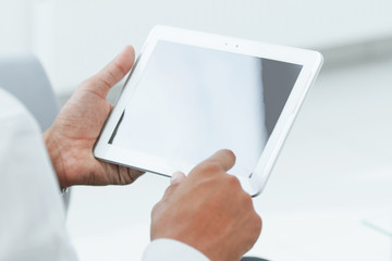 close up. businessman tapping the screen of the digital tablet