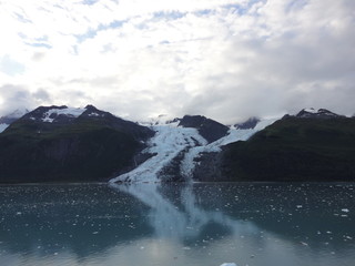 Glaciers within Glacier Bay National Park in Alaska. Glaciers coming over mountain peaks and...