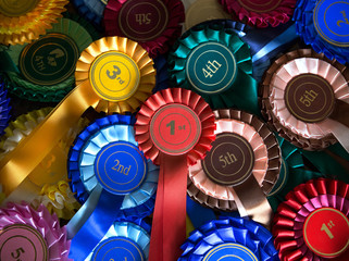 Pile of real rosettes badges with first, second third and fourth in the centre