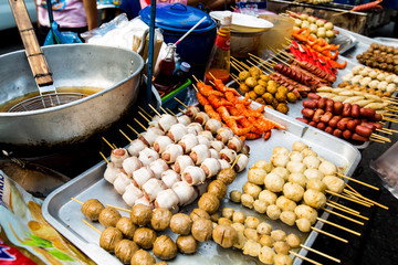 Street food in Thailand. Delicious, fried food on sticks.