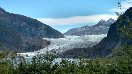 Naklejka na ściany i meble Mendenhall Glacier Juneau Alaska. Mendenhall Glacier flowing into Mendenhall Lake in between mountains with Nugget falls. Perfect tourist location