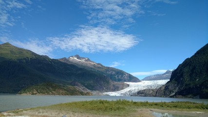 Mendenhall Glacier Juneau Alaska. Mendenhall Glacier flowing into Mendenhall Lake in between mountains with Nugget falls. Perfect tourist location