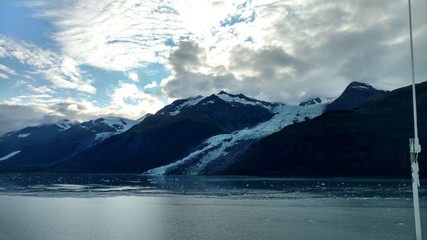 Glaciers within Glacier Bay National Park in Alaska. Glaciers coming over mountain peaks and sliding into the Pacific Ocean