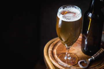 Glass beer on dark background with copy space