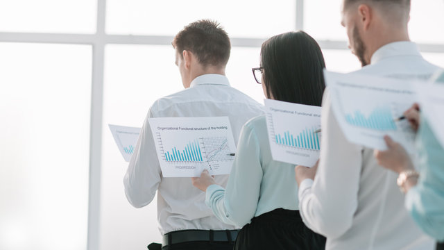 close up. employees with financial reports, standing in line. - Powered by Adobe