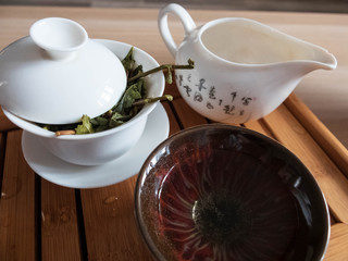 Tea brewing vessels with leaves of oolong tea on tea draining tray. Chinese traditional tea ceremony.