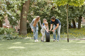 happy family playing for a walk in the courtyard of the cit