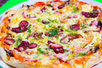 hot tasty fresh pizza on a plate close-up. green background