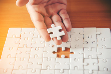 Jigsaw with one piece missing revealing