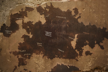 Map of the world on the wall of the street, of fallen plaster