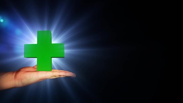Big green cross with bright light in hand. 56.