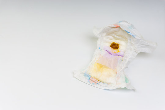 Kuala Lumpur, Malaysia - March 2, 2019 : Yellowish dirty feces of infant on diapers. Selective focus and crop fragment