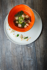 top view noodle soup with mushrooms, meat, and nettle leaves