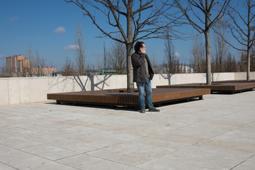Young attractive businessman working in the park.