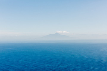 Yacht at the sea in Italy. Aerial view of luxury floating boat on transparent turquoise water at sunny day. Summer seascape from air. Top view from drone. Seascape with motorboat in bay.