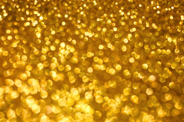 Christmas holiday abstract bokeh background with gold lights. Glitter golden bokeh background