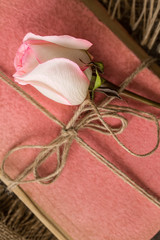 Pink rose on an old book in a vintage style