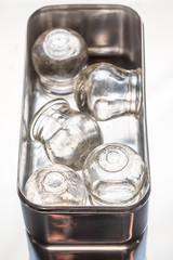 Old medical cupping glass in a stainless steel container