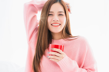 beautiful attractive asian woman  pink sweater with hot drink on white bed morning freshness healthy lifestyle