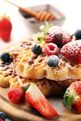 Waffle. Traditional belgian waffles with fresh fruit and powder sugar on wood