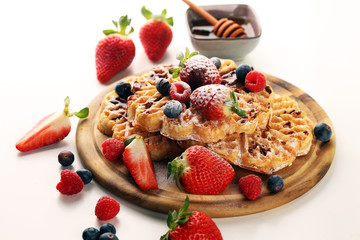Waffle. Traditional belgian waffles with fresh fruit and powder sugar on wood