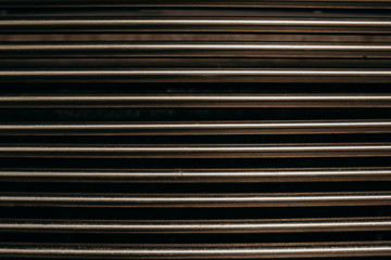 Fototapeta premium Stainless steel wall background. Metallic sticks. Reflection of the metallic color. Сlose up shot. Noise and gain