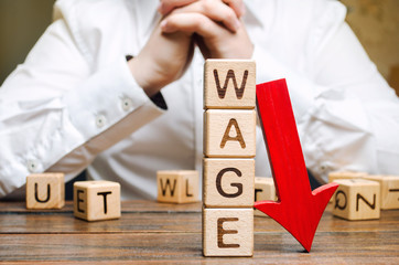 Wooden blocks with the word Wage and red arrow down. Salary reduction. Drop in profits. Financial...