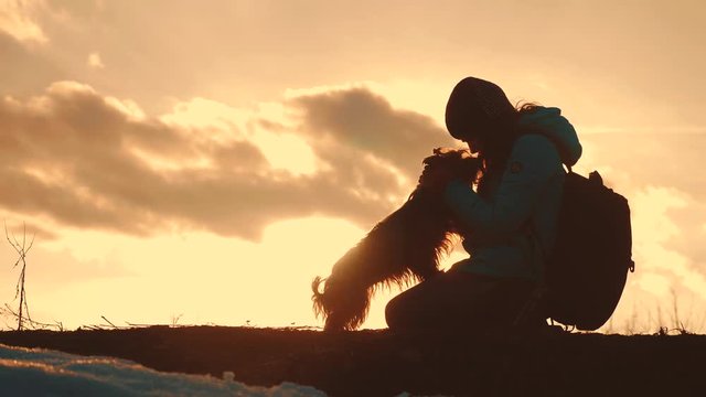 little girl daughter and dog teamwork happy family tourists silhouette concept holding hands spinning funny video. happy childhood. girl and dog team friendship and care with pets sunset play dabble