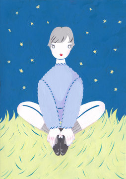 夜空の下原っぱに座る女の子