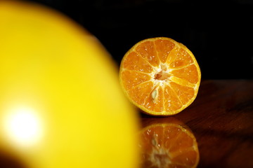 fresh oranges half cut on wooden table