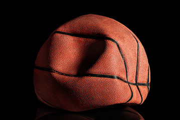 Deflated and rumpled old basketball ball