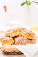 Ready-to-eat cottage cheese cookies in a basket on a wooden table