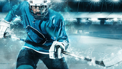 Ice Hockey player athlete in the helmet and gloves on stadium with stick. Action shot. Sport...