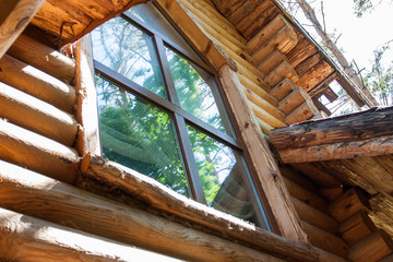The window of the second floor of a log house.