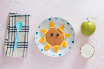 Funny pancakes with orange for kids breakfast