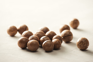 Superfood. Organic macadamia nut on stone background.