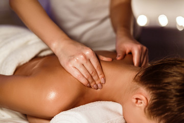 Fototapeta na wymiar Masseur making therapeutic neck massage for girl