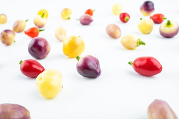 Fresh colorful peppers on white background
