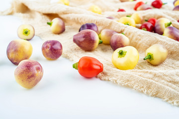 Fresh colorful peppers on burlap