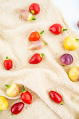 Fresh colorful peppers on burlap