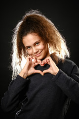 Emotional portrait of a girl with long curly hair on a black background,