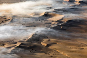 Fototapeta na wymiar Fog over the sand sea of Sossusvlei, Namibia.