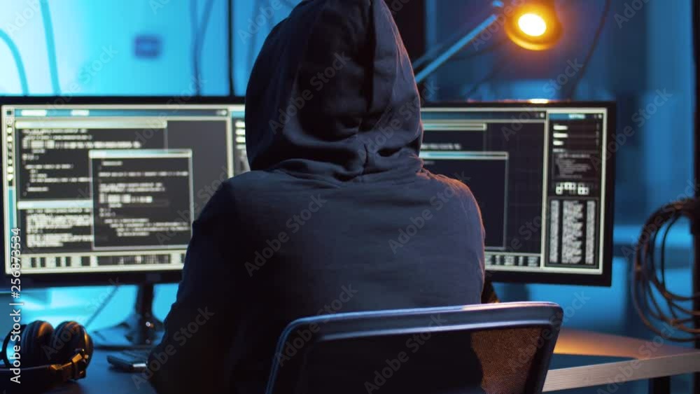 Poster cybercrime, hacking and technology concept - hacker in dark room creating code or using computer vir