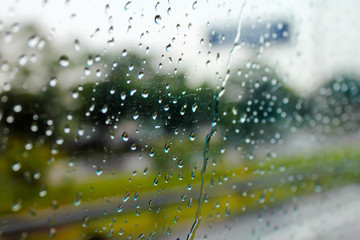 Raindrops on the window show the weather in the rainy season.