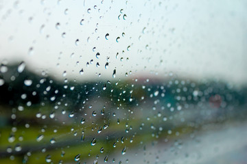 Raindrops on the window show the weather in the rainy season.