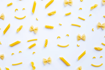 Different types of dry pasta on white.