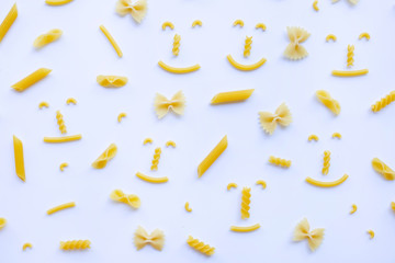 Different types of dry pasta on white.